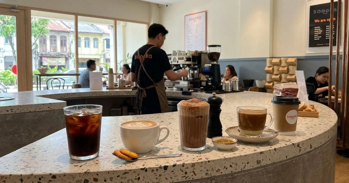 Array of beautifully prepared coffee drinks on a cafe counter including cold brew, latte, and traditional kopi